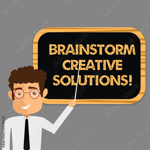 Text sign showing Brainstorm Creative Solutions. Conceptual photo intensive and freewheeling group discussion Man Standing Holding Stick Pointing to Wall Mounted Blank Color Board