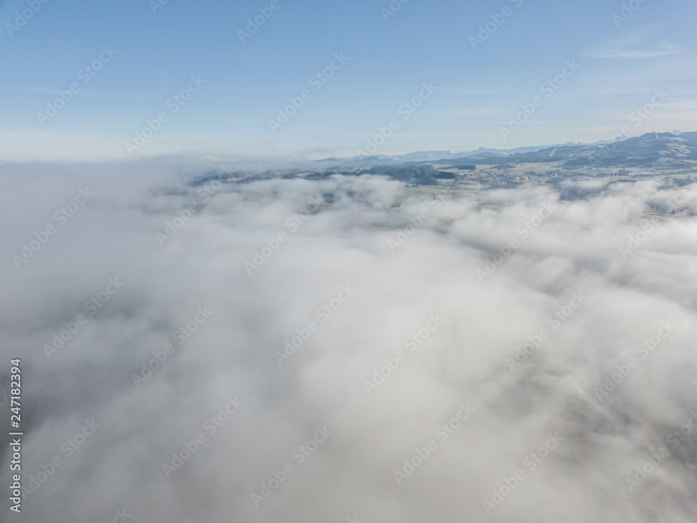 Aerial view of rural landscape in Switzerland covered with fog. Cold morning in winter with beautiful light. Aerial view of rural landscape in Switzerland covered with fog. Cold morning in winter with beautiful light.
