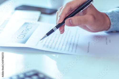 Businessman reading documents in office.