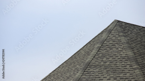 roof shingle background and texture. edge of rubber tile against blue sky.