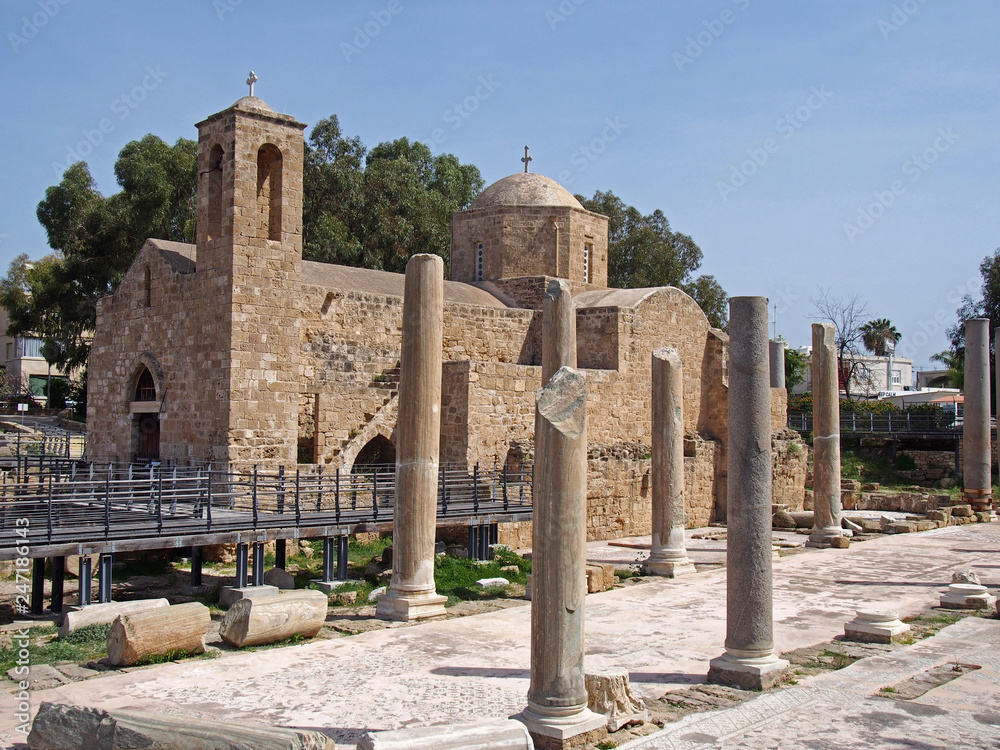 the historic church of ayia Kyriaki Chrysopolitissa in paphos cyprus showing the building and the surrounding old roman columns and ruins