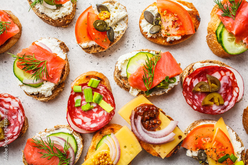 Assorted spanish tapas with fish, sausage, cheese and vegetables. White background, top view.