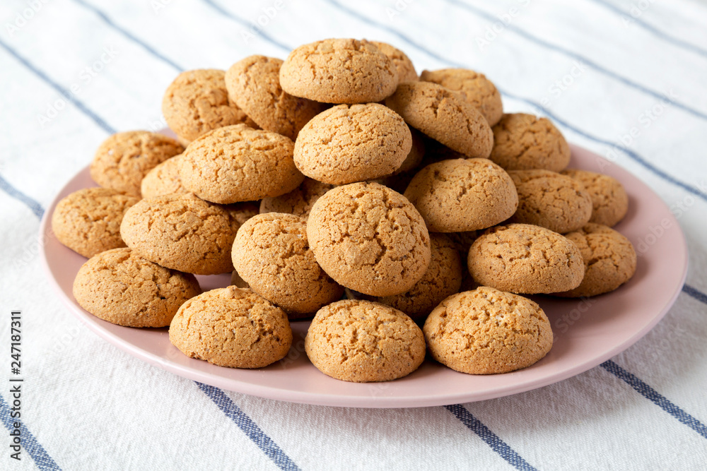 Homemade almond cookies on pink plate, side view. Closeup. Homemade almond cookies on pink plate, side view. Closeup.