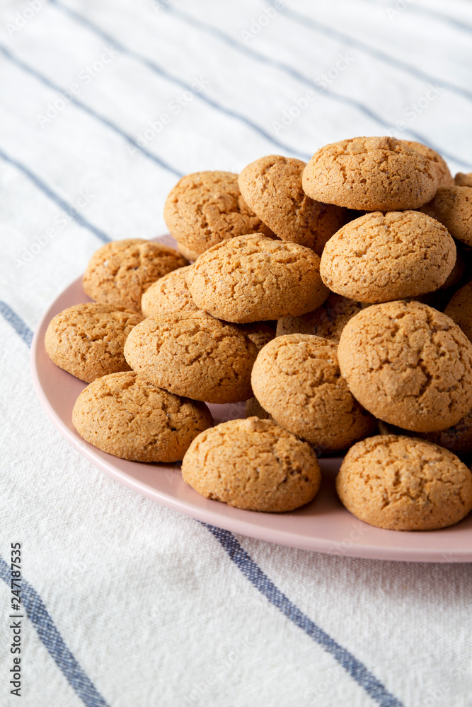 Homemade almond cookies on pink plate, side view. Close-up. Homemade almond cookies on pink plate, side view. Close-up.