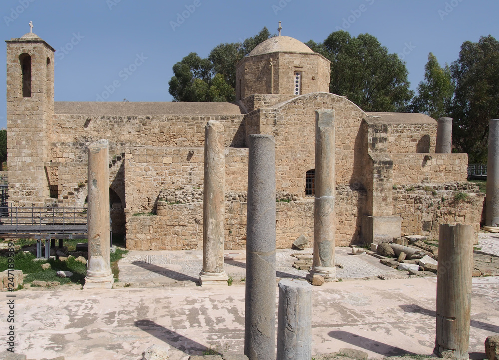 the historic church of ayia Kyriaki Chrysopolitissa in paphos cyprus showing the building and the surrounding old roman columns and ruins