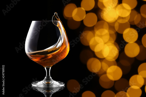 splash of brandy in snifter glass photo