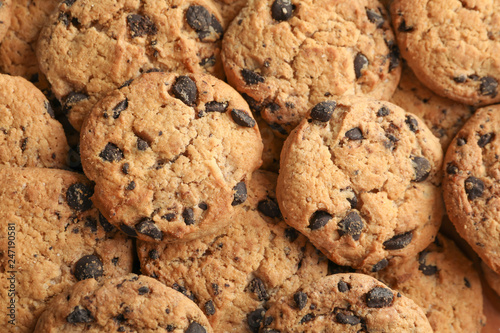 Tasty chocolate chip cookies as background  top view
