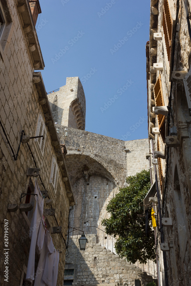 DUBROVNIK, CROATIA - AUDìGUST 22 2017: detail of historic redidential buildings and town walls of Dubrovnik