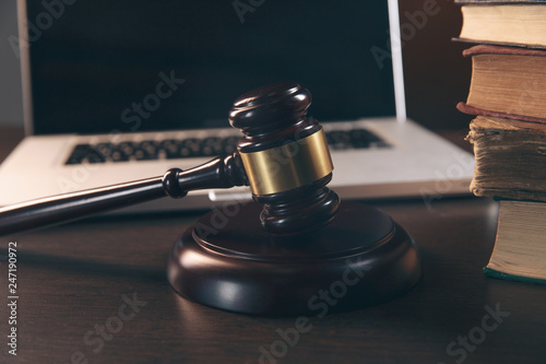 Gavel   laptop  books and scales on brown background  judiciary and legislature courtroom legal concept. top view flatlay lawyer background