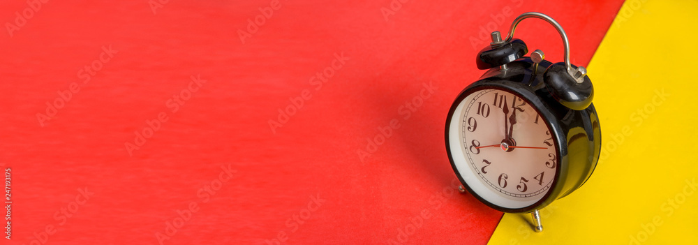 Black table clock on yellow and red banner template Black table clock on yellow and red banner template