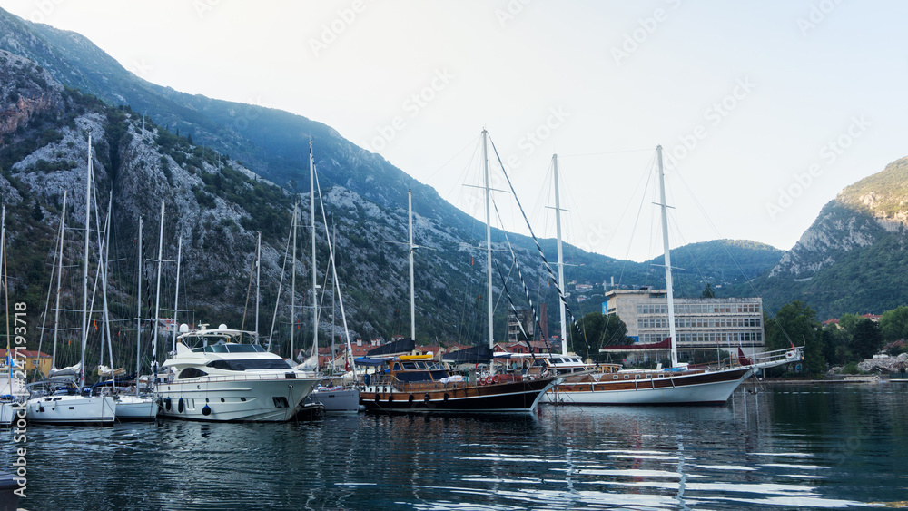 Yachts and boats in the bay on the background of mountains