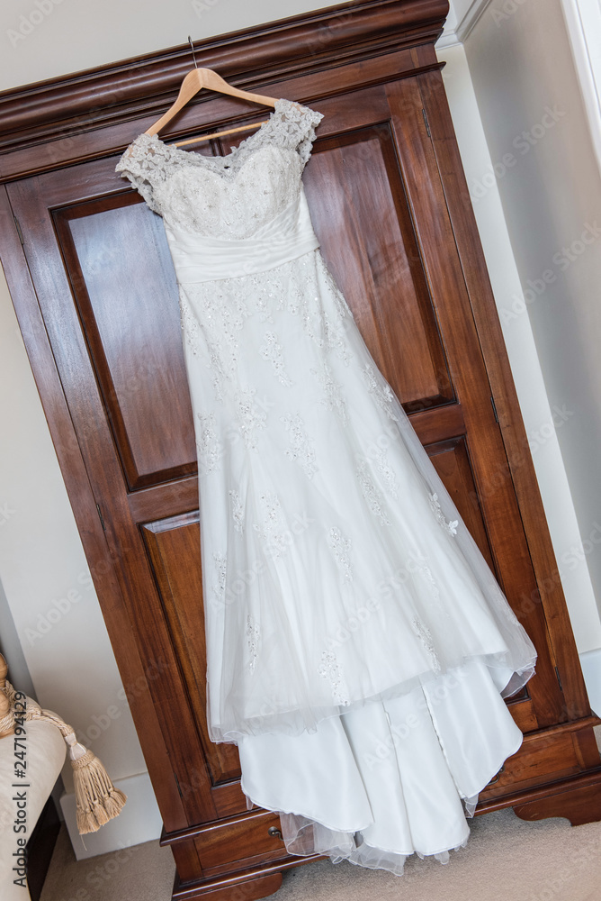 Wedding dress hanging up before the ceremony Wedding dress hanging up before the ceremony