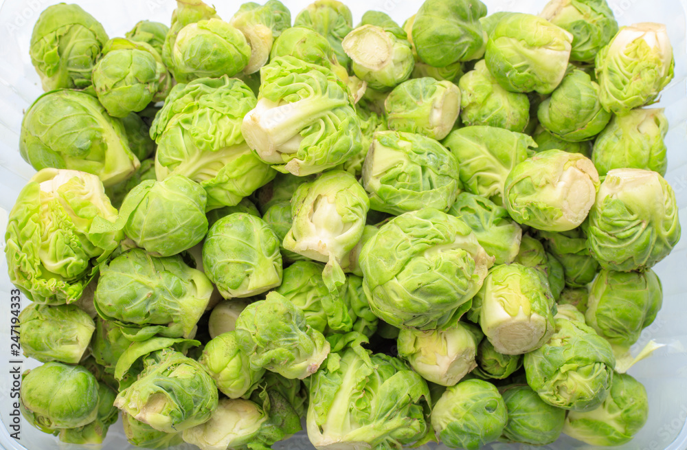 Brussels sprouts in a disposable container on a white background. View from above. The concept of healthy eating, diet. Background Texture