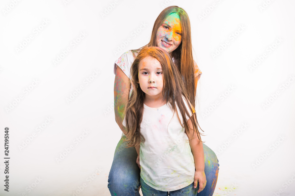 Family, holidays and festival of holy concept - dirty young woman and cute little girl having fun together on white background Family, holidays and festival of holy concept - dirty young woman and cute little girl having fun together on white background