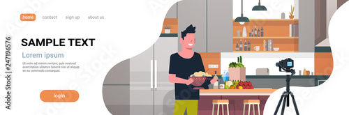 guy food blogger recording video on camera man preparing tasty dish modern kitchen interior cooking blog concept male character portrait flat copy space horizontal