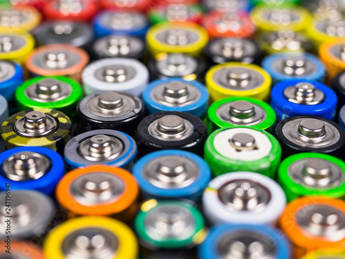 Huge number of AA batteries of different color. Batteries for use in the different equipment