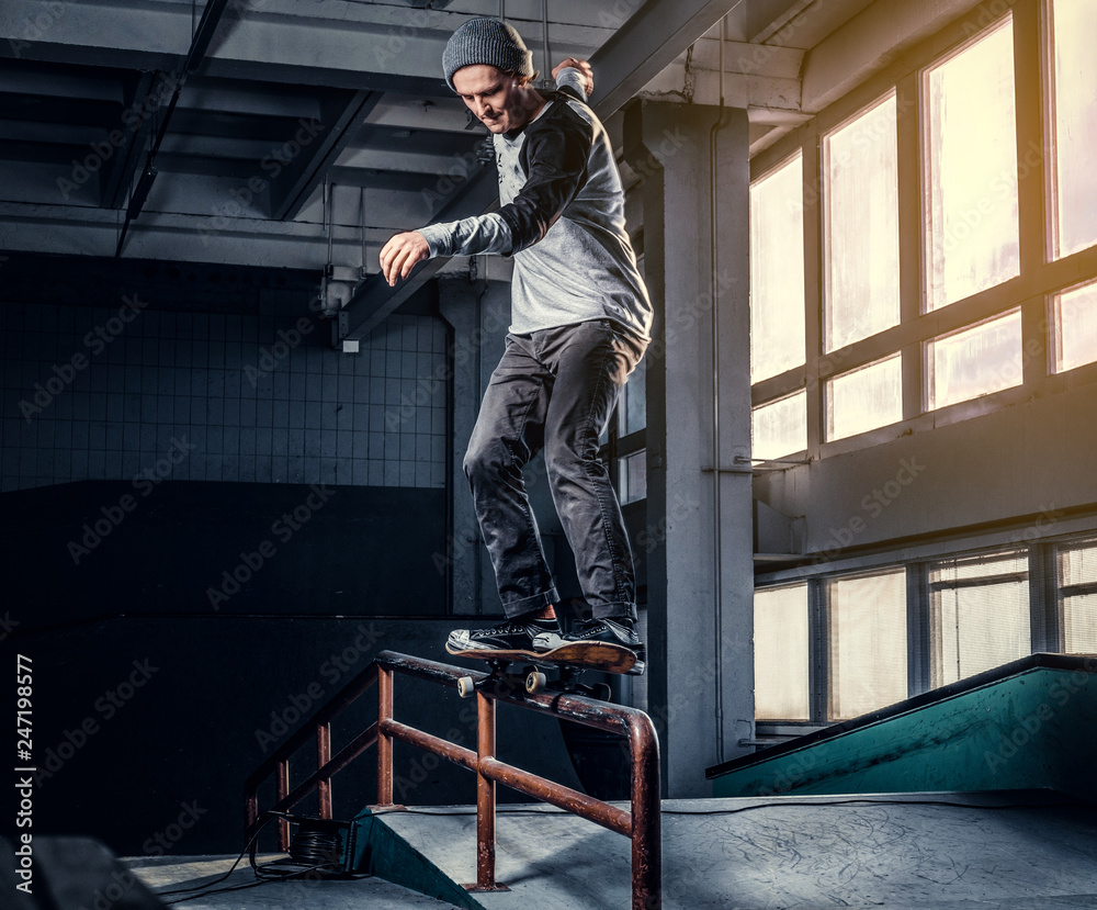 Skateboarder performing a trick on mini ramp at skate park indoor. Skateboarder performing a trick on mini ramp at skate park indoor.