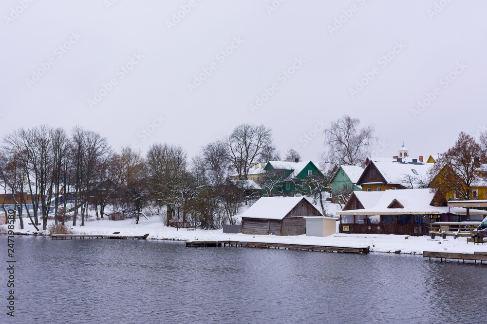 Fototapeta premium View on houses by the river side in winter