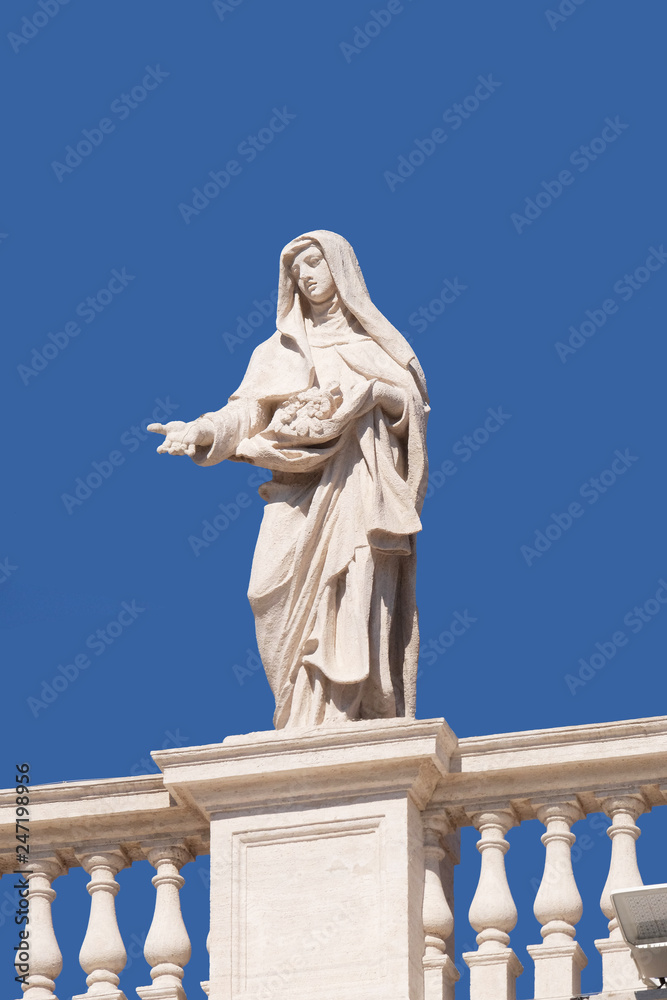 St. Elizabeth of Portugal, fragment of colonnade of St. Peters Basilica. Papal Basilica of St. Peter in Vatican - the world largest church, is the center of Christianity in Rome, Italy 