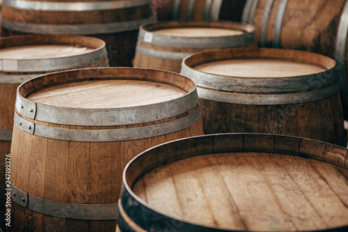 Old wooden wine barrels with iron hoops.