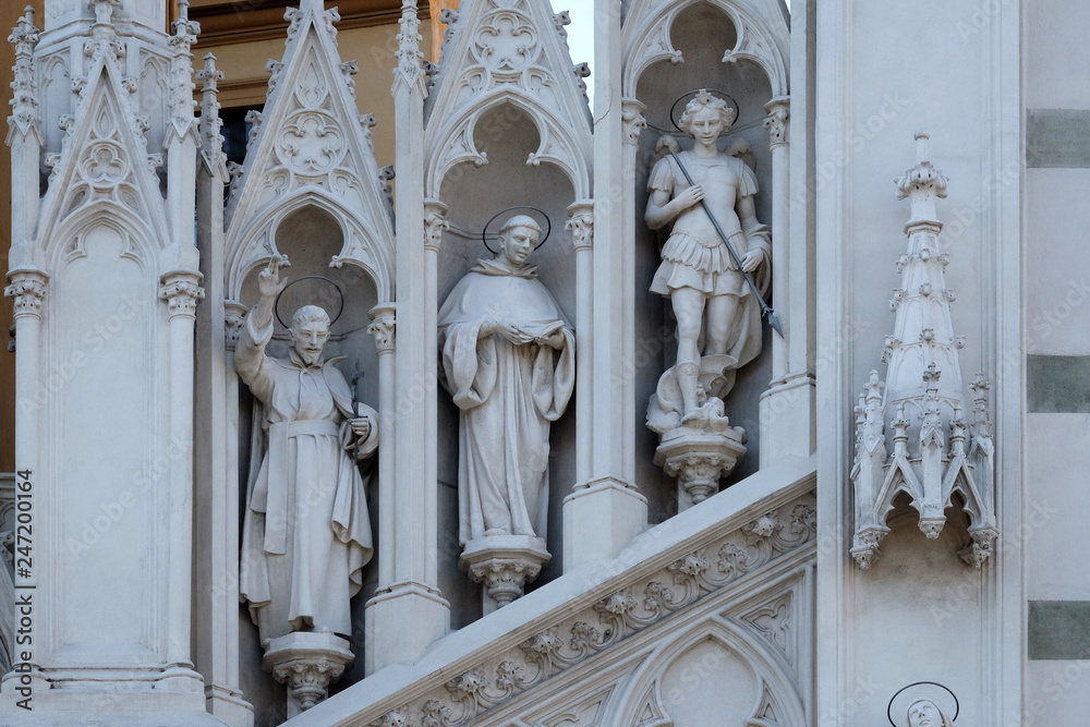 Statues of St. Francis Xavier, Dominic of Guzman and Michael Archangel on the facade of Sacro Cuore del Suffragio church in Rome, Italy  