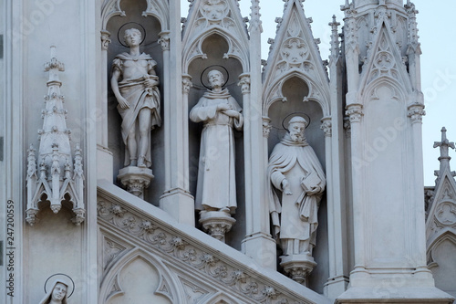 Statues of St. Victor, Francis of Assisi and Nicholas of Tolentino on the facade of Sacro Cuore del Suffragio church in Rome, Italy 