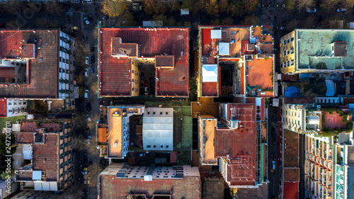 Perpendicular aerial view of a group of buildings in the Vomero district in Naples, Italy. All the roofs are walkable and full of antennas and TV dishes. down the streets lit by the sun. © Stefano Tammaro