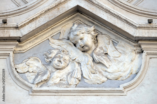 Angel, bass relief on the facade of Sant Andrea de Urso church in Rome, Italy photo