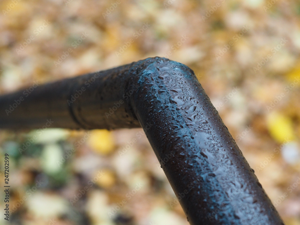 Bent metal pipe with drops of water