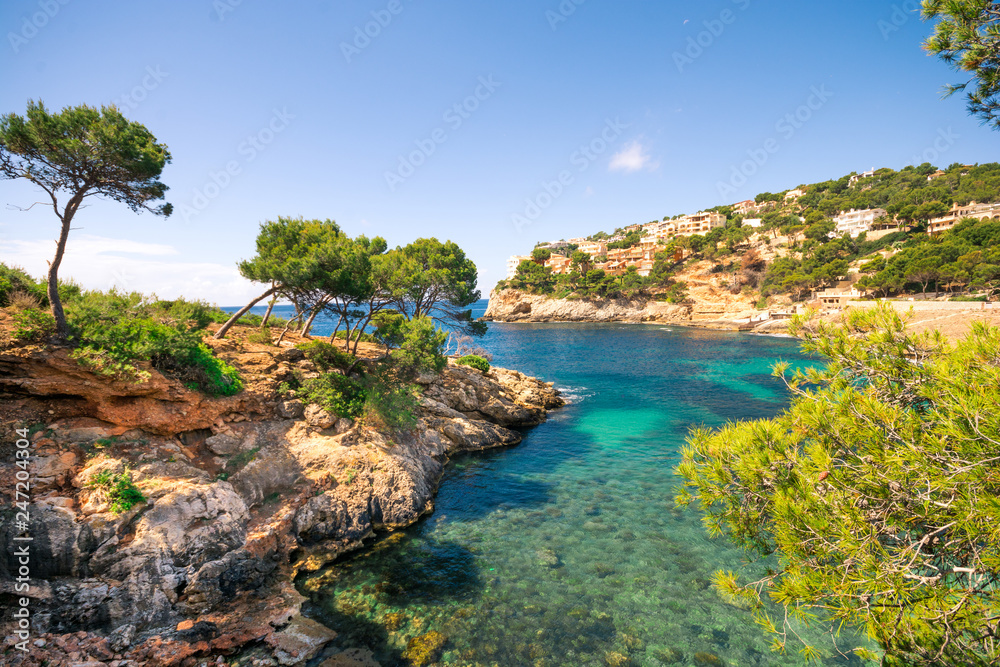 Beautiful cliffs and clear blue green water in bay Cala Marmassen Mallorca Spain