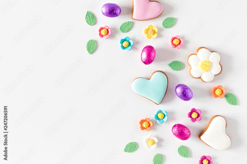Easter eggs, cookies, sweets, easter decorations on white background. Minimum Easter holiday concept. Flat lay, top view, copy space