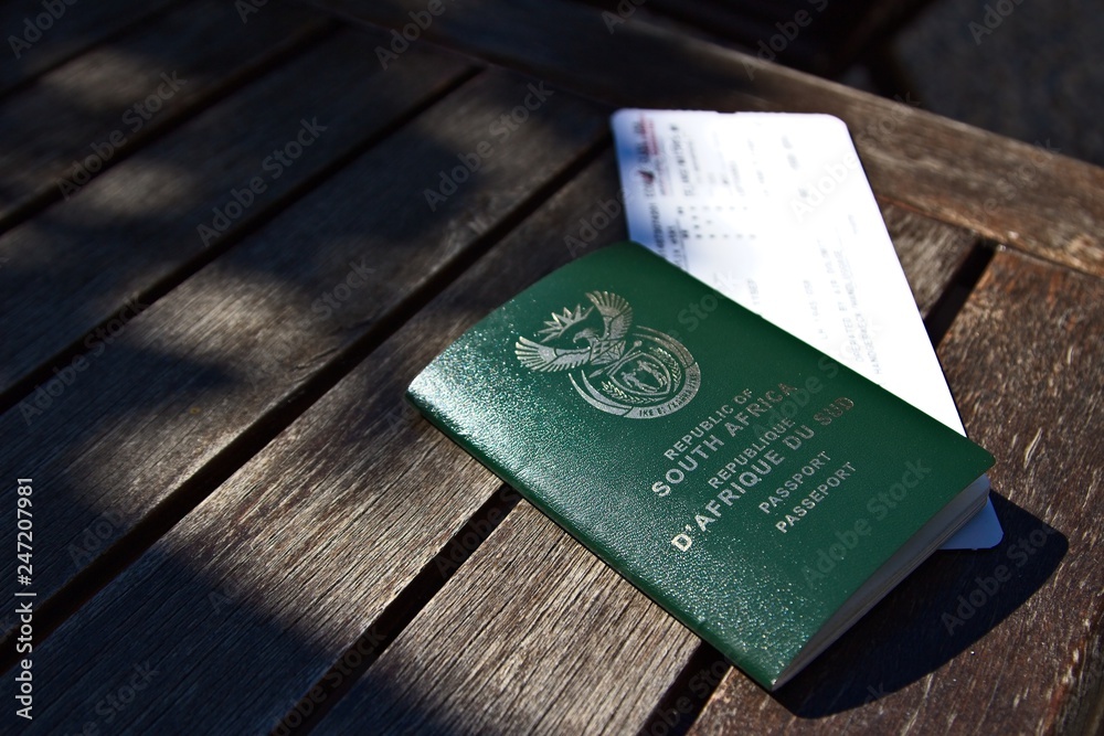 A South African passport and a plane ticket. Travel or immigration concept  image. Photos | Adobe Stock