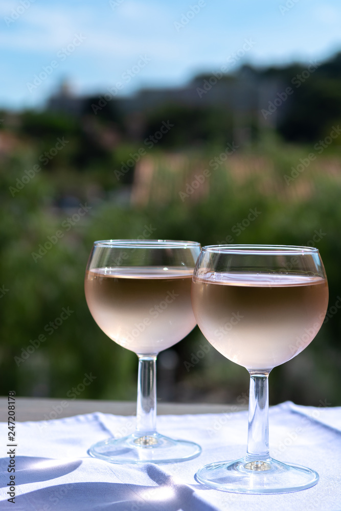 Rose wine of Provence, France, served cold on outdoor terrace in two wine glasses Rose wine of Provence, France, served cold on outdoor terrace in two wine glasses