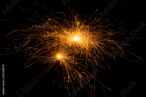 Bengal fire. New year sparkler candle on black background