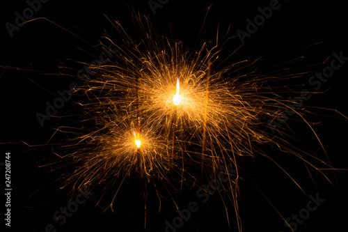 Bengal fire. New year sparkler candle on black background