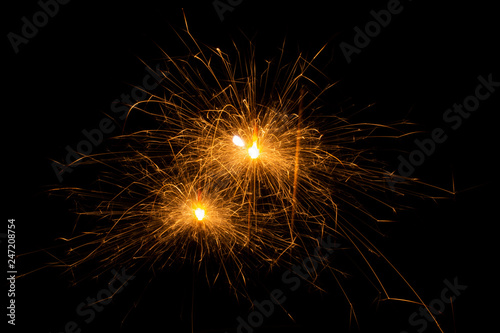 Bengal fire. New year sparkler candle on black background