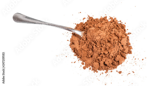 pile of ground carob powder with steel spoon