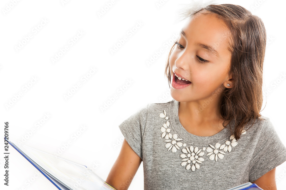 Lovely happy little girl reading a book isolated on white background Lovely happy little girl reading a book isolated on white background