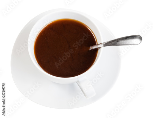coffee drink in white cup with spoon on saucer
