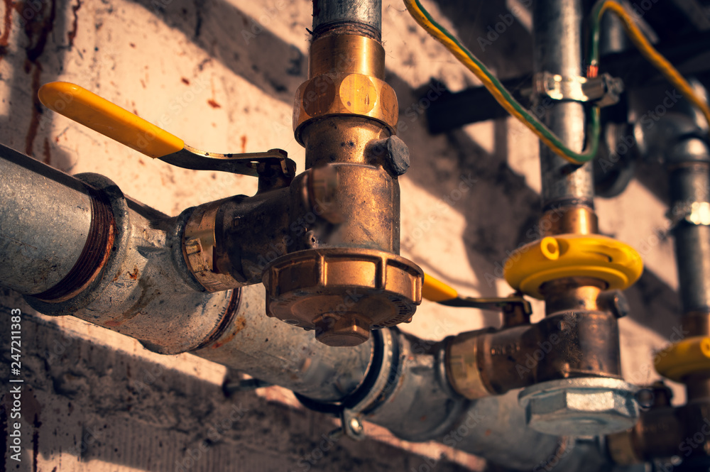 Copper faucet with copper pipe and water pipe in front of a masonry Copper faucet with copper pipe and water pipe in front of a masonry