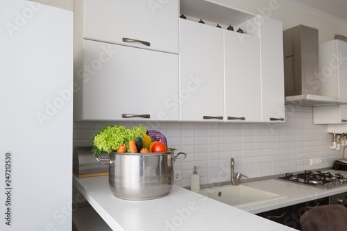 Interior. Kitchen modern, white, brown, beige color, fruits and vegetables