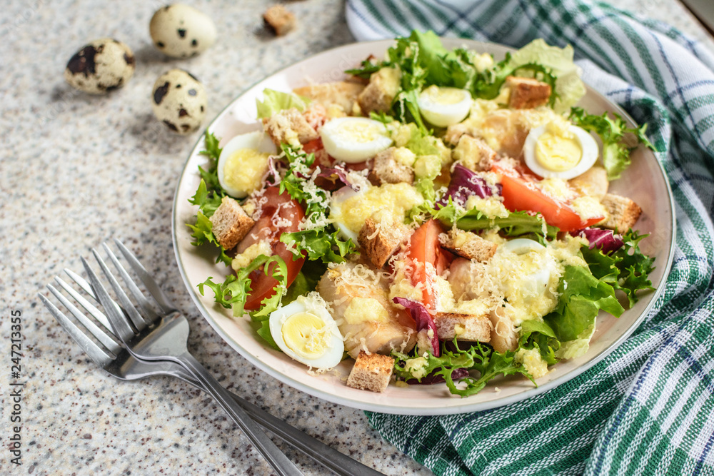 Fresh caesar salad with chicken breast, lettuce and tomatoes. Delicious spring salad Fresh caesar salad with chicken breast, lettuce and tomatoes. Delicious spring salad