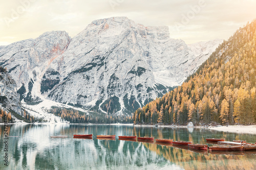 A magical panoramic landscape with calm colors of the famous lake Braies in the Dolomites Alps during autumn season. A popular tourist attraction