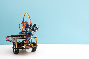 Hand made robot working on the arduino platform. White background. Free space for text. STEM education for children and teenagers, robotics and electronics. DIY. AI. STEAM.