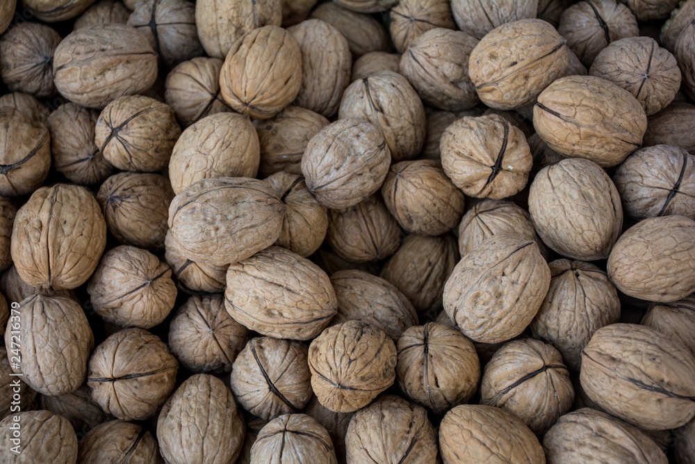 Dry Fruit walnuts are Laying in a basket making background Dry Fruit walnuts are Laying in a basket making background