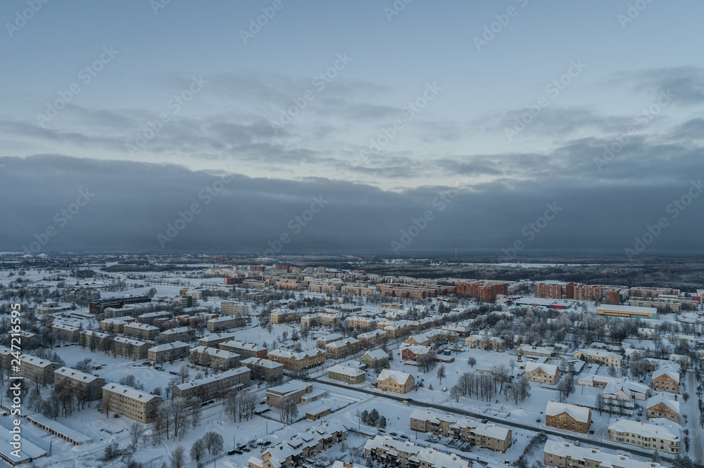 Aerial view of the city on a cold winter morning. Sunset on a foggy day.