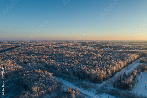Aerial view of a beautiful sunset in the winter forest.  © nikwaller