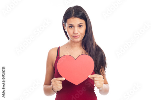 beautiful happy brunette woman holding and showing a big red heart © JPchret