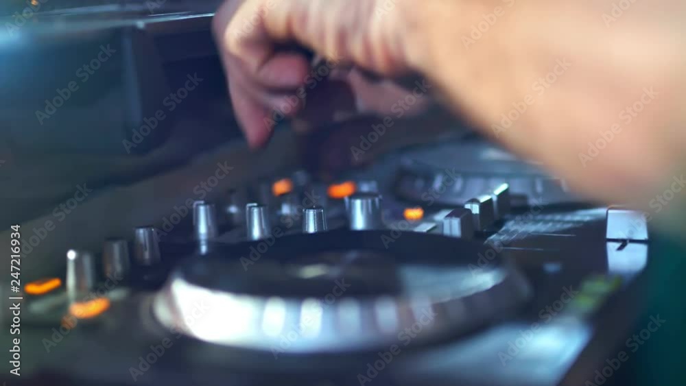 DJ is using a controller to mix a music DJ is using a controller to mix a music