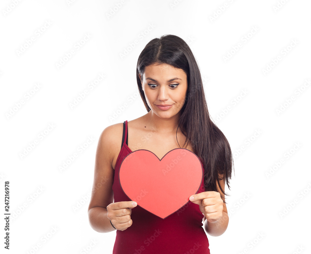beautiful happy brunette woman holding and showing a big red heart beautiful happy brunette woman holding and showing a big red heart